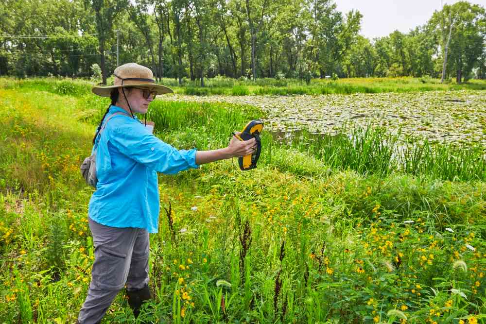 TWI Lead Ecologist Katie Kucera marks a survey point at Indian Ridge Marsh in Chicago. Photo by TWI.